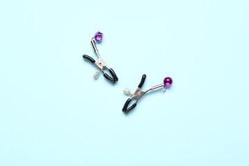 New nipple clamps from sex shop on blue background