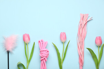 Composition with sex toys and tulip flowers on blue background