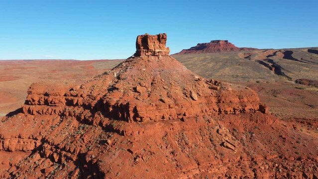 Red rocks butte tower of brick canyon formation crumbling from erosion. Cliff tower of oranges and stone in red heat desert usa. Aerial view at sunset light. Road trip in Arizona Utah Nevada state