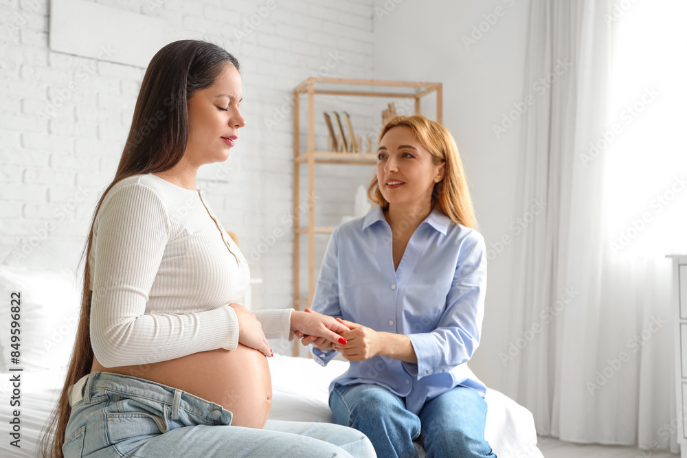 Canvas Prints Mature doula with pregnant woman holding hands in bedroom