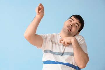 Young man on blue background. National Cerebral Palsy Awareness Month