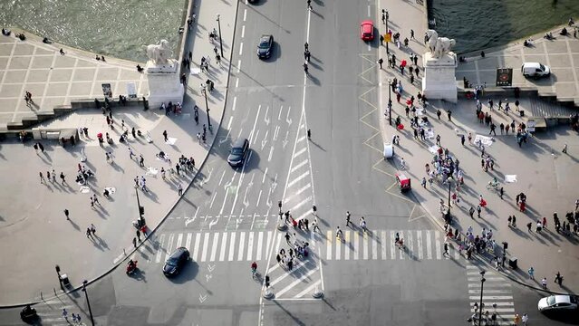 Many pedestrians and cars seen from above on Iena bridge over the river Seine in Paris, France.