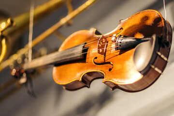 A worn violin hanging from wires in the ceiling found in a Norwegian museum.