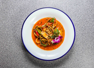 fried clam with chilli paste with cucumber and coriander served in plate isolated on grey background top view of hong kong fastfood