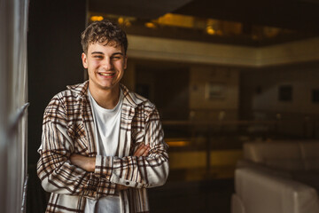 Portrait of young caucasian man stand and smile indoor