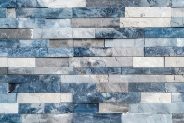 Modern cladding stone tiles forming a textured wall background with a pattern of rectangular shapes in blue and grey color tones
