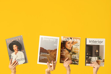 Female hands with different magazines on yellow background