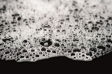 Foam texture. Soap suds with bubbles. Foam on a damp background