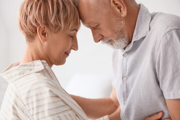 Mature couple hugging in clinic, closeup