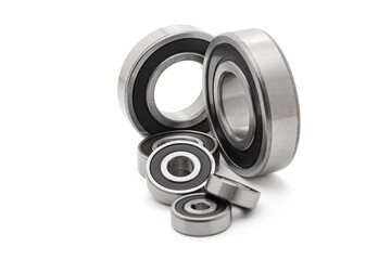 A collection of assorted tapered roller bearings of various sizes, isolated on a white background.