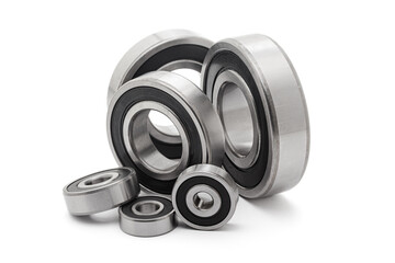 A collection of assorted tapered roller bearings of various sizes, isolated on a white background.