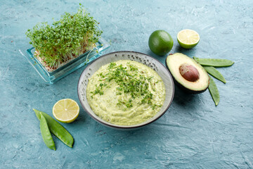 Traditional exotic spring dip with avocado and roasted vegetables served as close-up in a Nordic design bowl