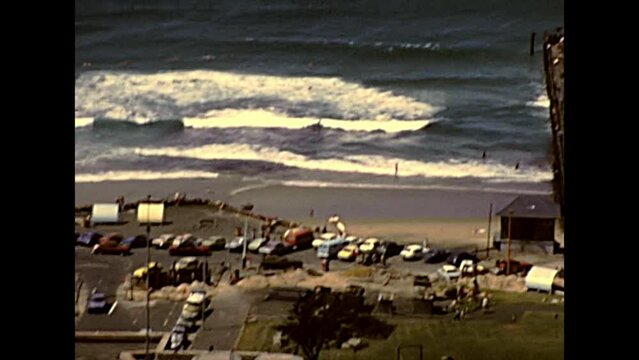 DURBAN, South Africa - circa 1981: Top aerial view of the waterfront and beach of Durban with people and cars. Historical archival footage in Durban harbor of the 1980s in South Africa.