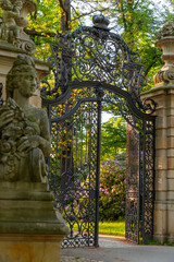 Fototapeta premium gate to the park in the town of Walbrzych at sunset in spring