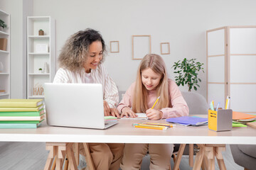 Little girl studying Math with tutor at home