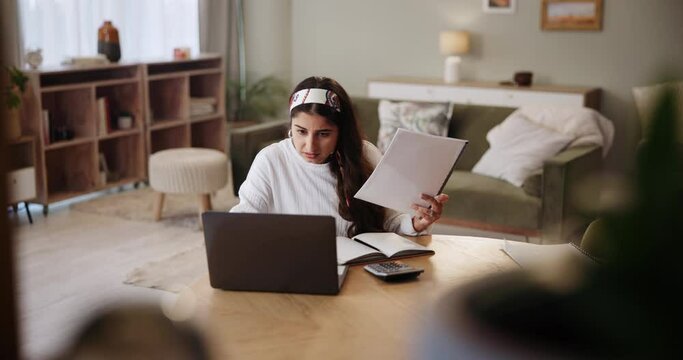 Woman, laptop and doubt for paperwork in home, budget and accountant for audit information. Female person, online tax website and confused for documents, plan and mistake or fail on finance report