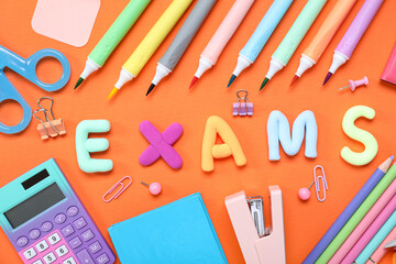Composition with word EXAMS and colorful stationery on orange background