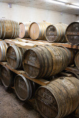 Aging process of cognac spirit in old dark French oak barrels in cellar in distillery house, Cognac white wine region, Charente, Segonzac, Grand Champagne, France