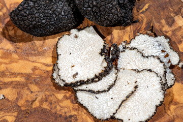 Slices of Italian black summer truffle, tasty aromatic mushroom, close up
