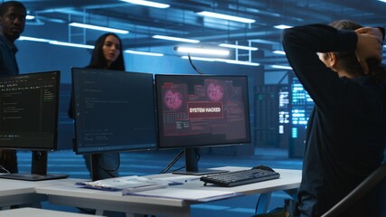 Programmer in server hub workspace requesting assistance from colleagues during hacking attack on...