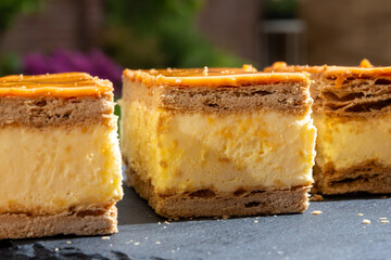 Celebration of the King birthday in Netherlands, tompoes or tompouce, iconic pastry in Netherlands made from puff dough, orange icing, cream