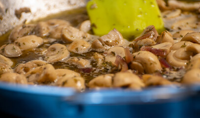 Vegetarian street food in Germany, roasted champignons mushrooms with sour cream