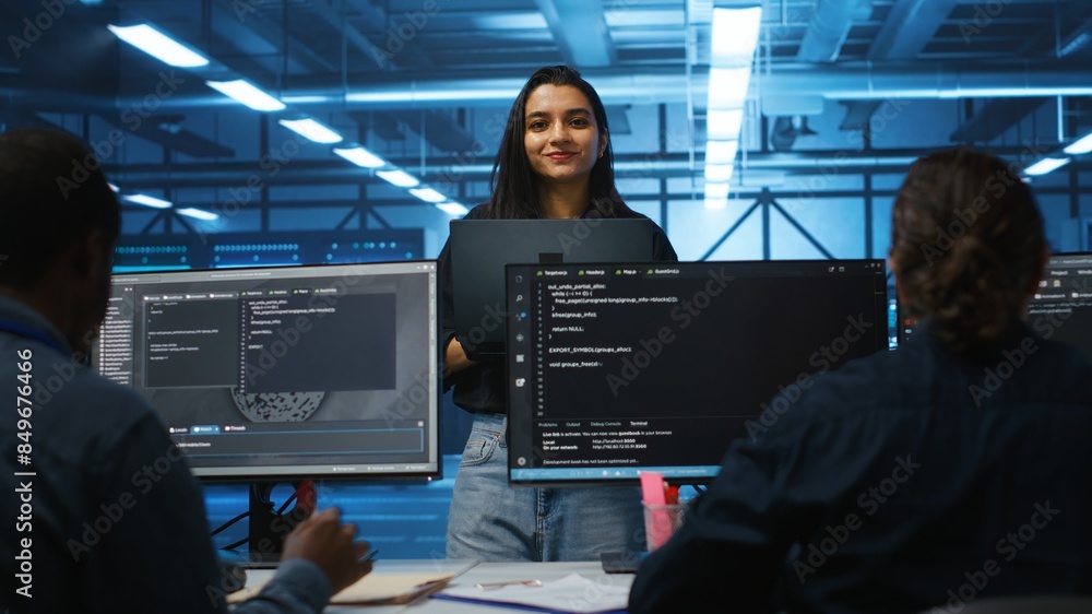 Poster portrait of smiling indian manager in server room managing team of engineers looking for equipment m