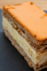 Celebration of the King birthday in Netherlands, tompoes or tompouce, iconic pastry in Netherlands made from puff dough, orange icing, cream