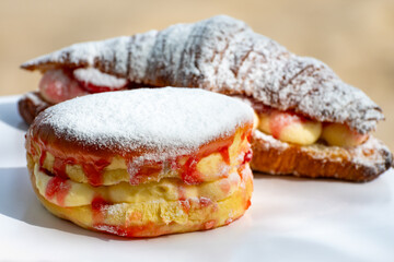Dutch cuisine, fresh baked strawberry cake and croissant with cream and fresh fruits