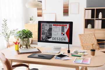 Graphic designer's workplace with tablet and computer in office