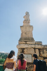 People looking at the Odeon of Agrippa in Athens, Greece. 