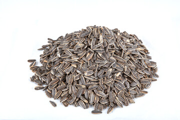 Roasted Salted Dakota Sunflower Seeds. Pile of black roasted salty sunflower seeds with flower on rustic table, nut concept, Helianthus annuus.