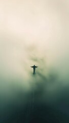 Silhouette of Jesus Christ statue in the fog.