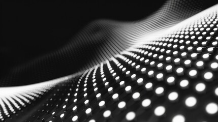 Dynamic black and white abstract image of a wave pattern created by arranged dots, conveying a sense of motion