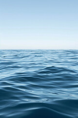 A solitary wave in a calm sea under a clear sky.