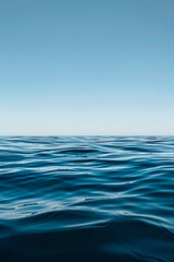 A solitary wave in a calm sea under a clear sky.