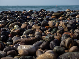 Pebbles on the sea coast. Stones close-up. Coast of the resort shore.