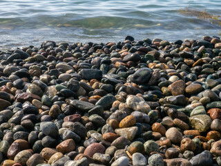 Pebbles on the sea coast. Stones close-up. Coast of the resort shore.