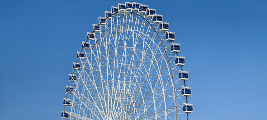 Big Ferris wheel against blue sky