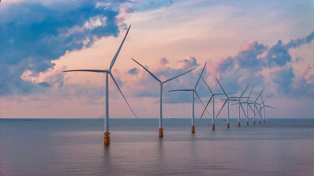 Landscape with Turbine Green Energy Electricity, Windmill for electric power production, Wind turbines generating electricity on ocean at Ba Dong, Tra Vinh, Vietnam. Clean energy concept.