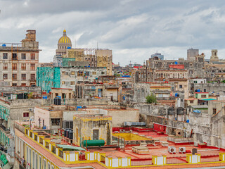 Fototapeta premium Havana from the above. View over the rooftops of Havana in Cuba with the Capitol. Rooftops of Old Havana, Cuba on a cloudy day. View of rooftops of old houses