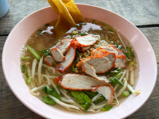 spicy thai noodle soup with pork, chicken and vegetable