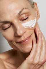 Close-Up Photo of Middle-Aged Woman Applying Face Cream, Daily Anti-Aging Skincare Routine
