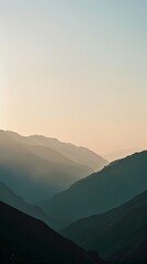 Morning Serenity: Aerial View of Mountains Silhouetted in Early Light