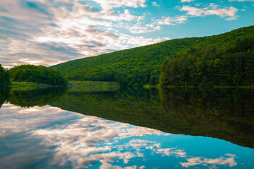 Sunny day view of lake in the mountains. 
