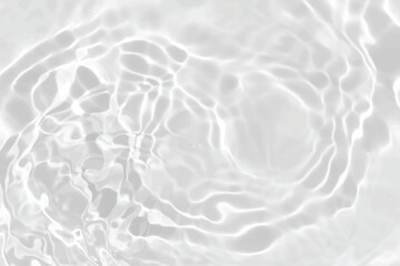 White water with ripples on the surface. Defocus blurred transparent white colored clear calm water surface texture with splashes and bubbles. Water waves with shining pattern texture background.