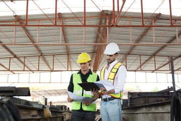 Engineer team discuss and examine a building construction.