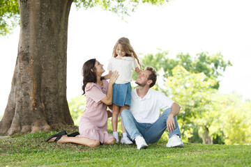 Fototapeta premium Caucasian family parent and their children picnic at the park in morning.