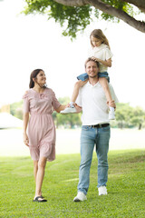 Fototapeta premium Caucasian family parent and their children picnic at the park in morning.