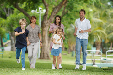 Obraz premium Caucasian family parent and their children picnic at the park in morning.